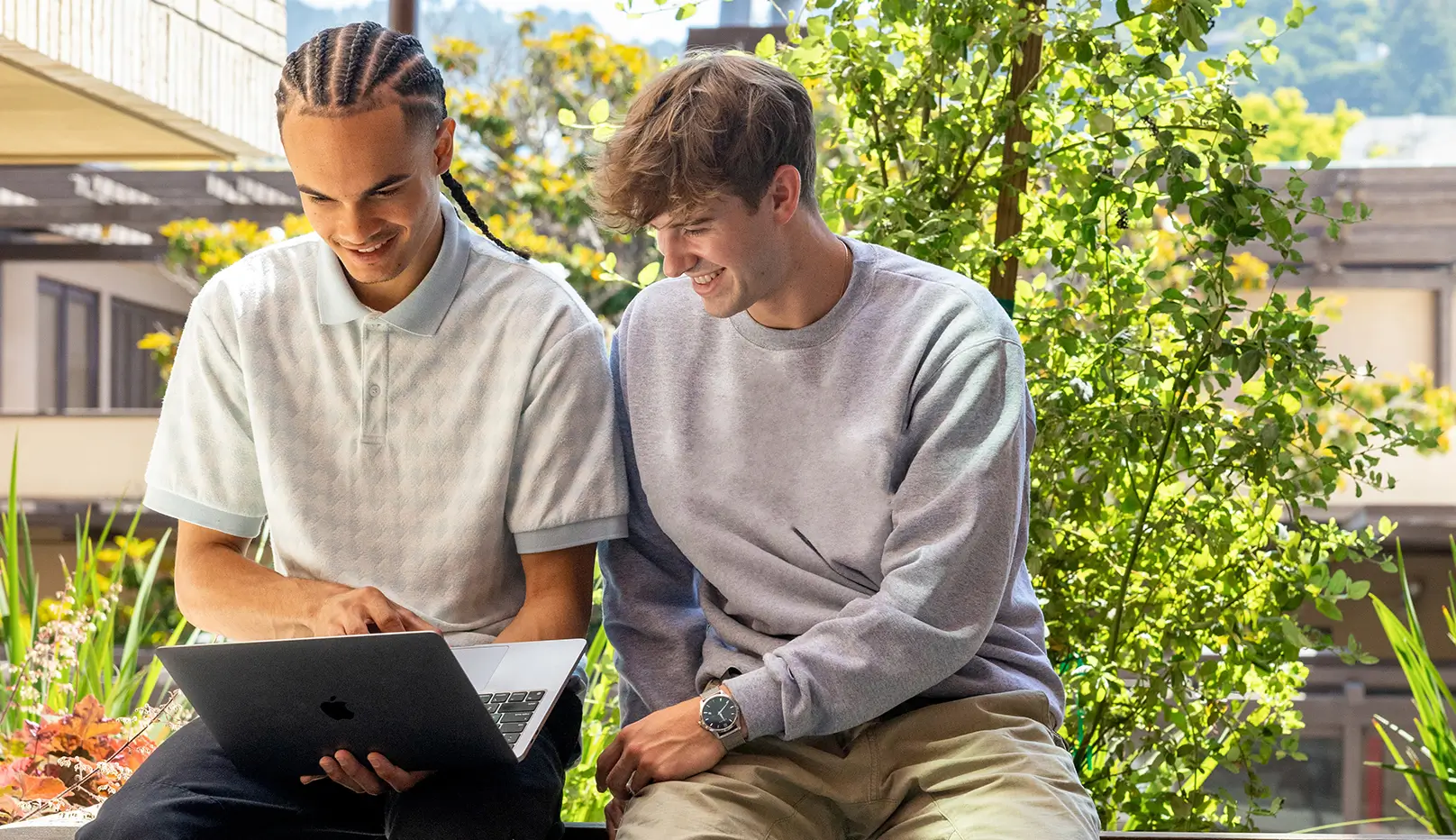 two men looking at a laptop
